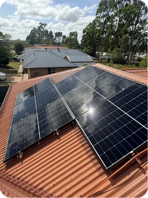 Residential solar panels fitted with bird proofing mesh around the panel edges on a corrugated metal roof
