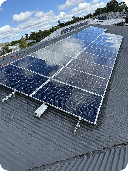 Large rooftop solar system fitted with bird proofing mesh around the panel perimeter on a metal roof