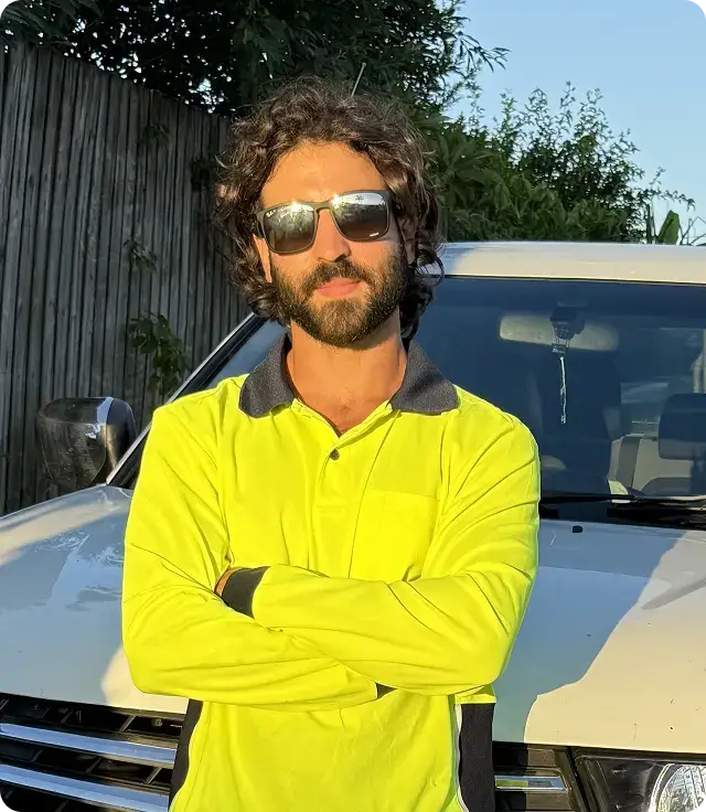 EZY Solar Cleaning team member standing in front of a service vehicle