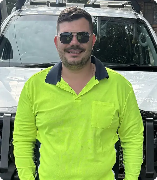 EZY Solar Cleaning team member standing in front of a service vehicle