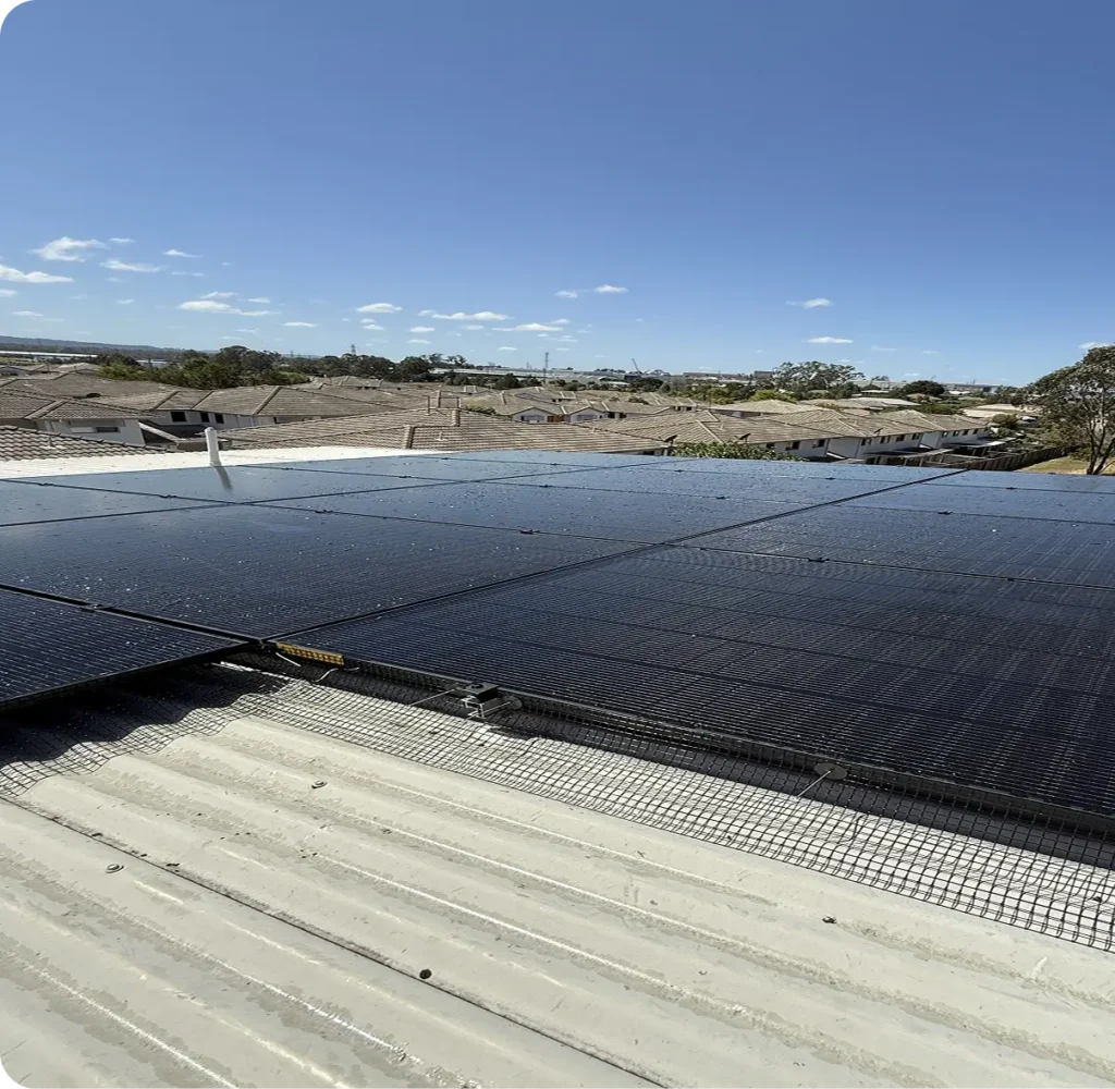 Completed bird proofing mesh installation around rooftop solar panels on a metal roof